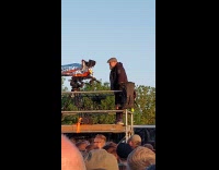 Crowd cheer for cameraman drink a shot