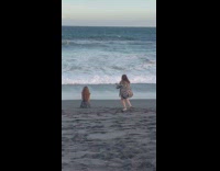 Photographer gets all angles of girl posing on sand 