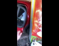 Red car door open very close to concrete column