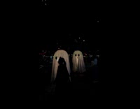 Couple as glowing ghosts for Halloween 