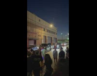 People party with DJ next to garages 