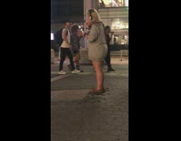 Woman with headphones brushes teeth in public