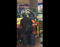 Guy clown face mask watching guy play on orange yellow piano 