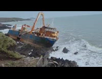 Abandoned ship on the rocky shore at the beach