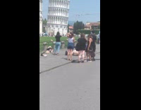 Tourists pose and hold Tower of Pisa for pictures 