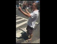 guy yelling about money on street corner