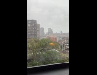 Shirtless men drinking and playing beer pong on rooftop 