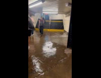 Water spills and leak on subway wall
