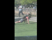 Man does push ups with dog in backpack 