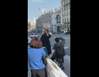 Woman walks with feminist sign picture