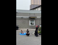 Woman on inflatable pool outside mcdonalds having photoshoot 