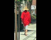 Collab WINY - Man on red poncho walking barefoot 