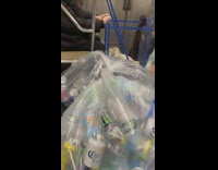 Man with a lot of recyclables riding the subway