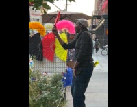 Man dance on street close open fan