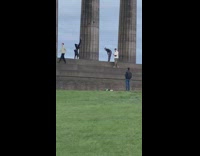 Girl handstand pillar guy interrupt photo shoot 