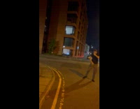 Man plays soccer on street 