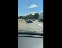 Bag hanging on car rear wiper highway