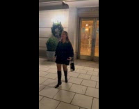 Woman holds bag tries to spin around