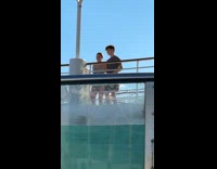 Two person swim wear dances near pool