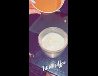 Girl pours whipped cream on coffee dalgona