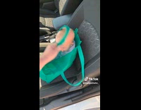 Woman carries baby on reusable shopping bag