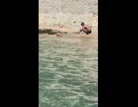 Bikini girl laying in water photo guy squatting 