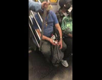 Guy on subway with two metal balls 