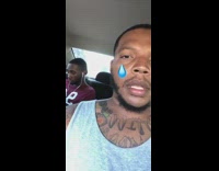 Guy stares at camera while friend sings in car