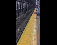 Bald guy does push ups on subway platform 