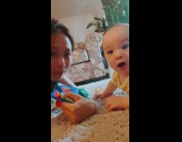 Curious baby crawls towards phone