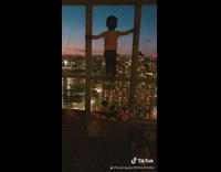 Little kid baby standing on window city