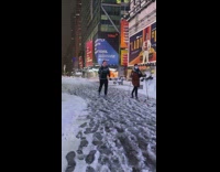 Guy and girl ski across times square 