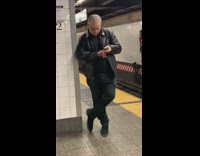 Guy waiting for subway cuts his nails 