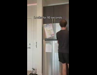 Guy walks to kitchen and then goes back to couch 