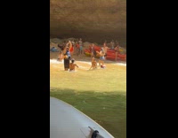 Collab IITW - Men Raises Arms Up as Wave Crash into Them