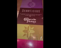 Woman at restaurant reading menu orders off skinnylicious menu