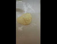 Orange white cat makes caramel buns chef