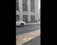 Guy riding unicycle on sidewalk while juggling 
