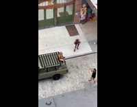 Woman in bikini top sits on top of the car