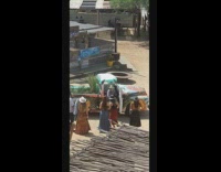 Girls take turns posing with blue truck 