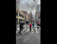 Newscaster shows burning building