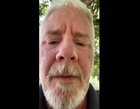 Old guy twerks in front of white car 