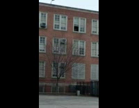 Collab WINY - Guy throws out trashbags into outside garbage bin from third floor window 