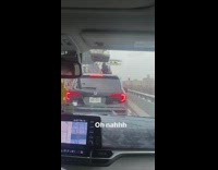 Lady Stands in SUV Sunroof While in Traffic