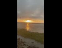 Collab DailyDoseOfInternet - Sunset grey clouds car ride near water