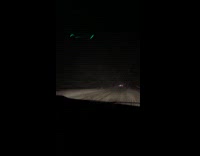 Car driving through snowstorm in the dark 