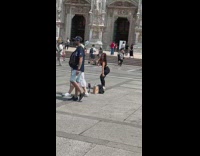 Woman in black crop top tiktok in front of the cathedral