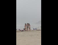 Three women bikini tiktok video shoot hazy beach