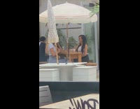 Two girls take photos of themselves eating