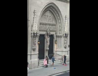 Woman posing for photo in front of cathedral like building